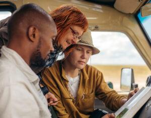 Guide and guests looking at birding book