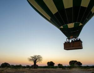 Hot air balloon rising at sunrise