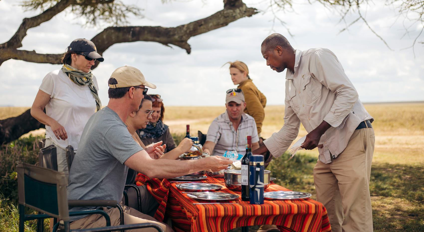Guests enjoying a bush breakfast in the serengeti.