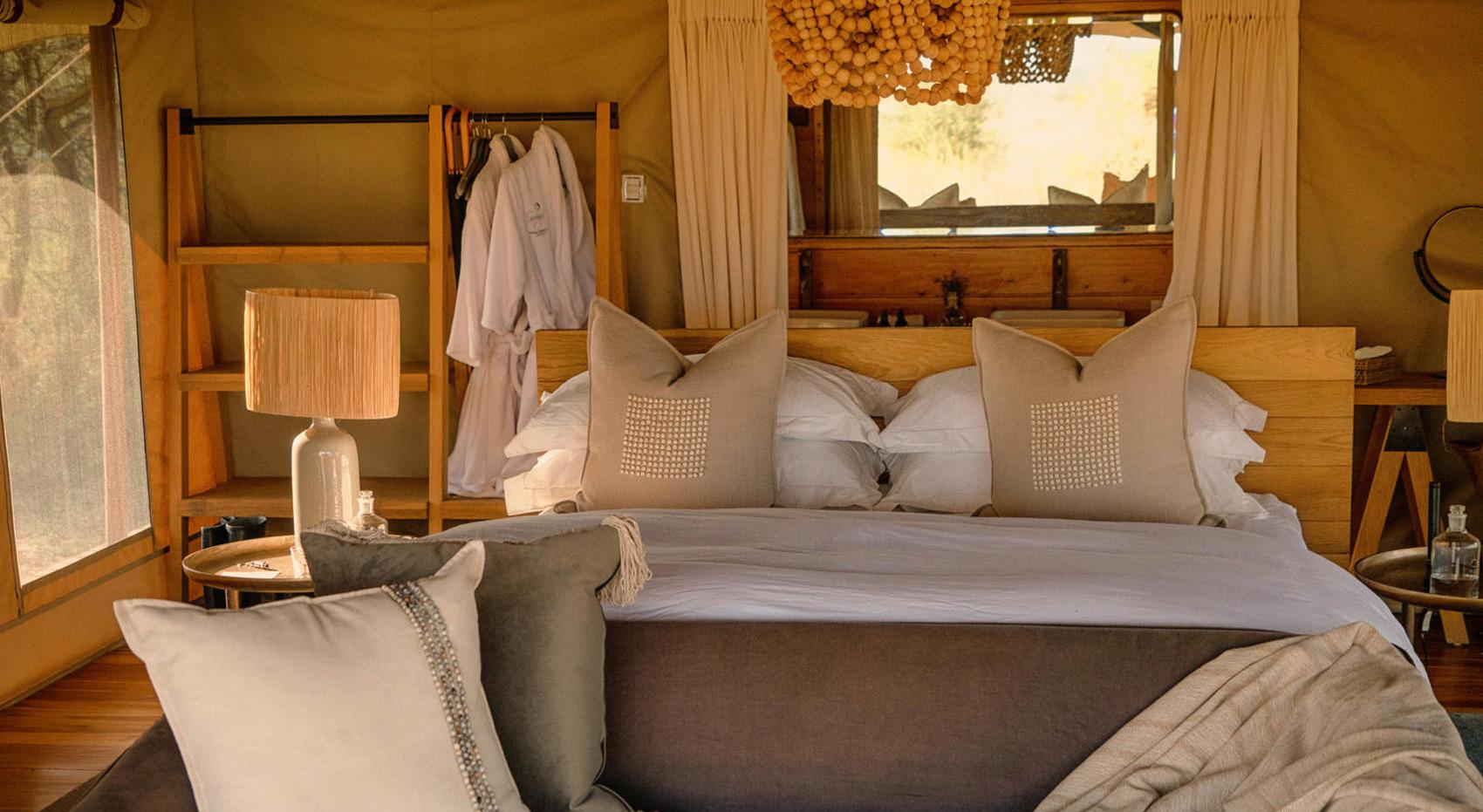 Beautiful tent with opulent bedding at Siringet Serengeti Camp. Beautiful tent with opulent bedding at Siringet Serengeti Camp.